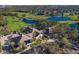 Aerial view of community clubhouse with golf course and lake at 5023 Tobermory Way, Bradenton, FL 34211