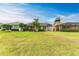 View of backyard with home and tropical landscaping at 5023 Tobermory Way, Bradenton, FL 34211