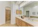 Double vanity bathroom with a large mirror and a walk-in shower at 5023 Tobermory Way, Bradenton, FL 34211