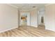 Spacious bedroom with wood-look floors and views into kitchen and bathroom at 5023 Tobermory Way, Bradenton, FL 34211
