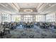 Bright dining room with many tables and chairs at 5023 Tobermory Way, Bradenton, FL 34211