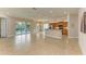 Open living room and kitchen with tile flooring and pool view at 5023 Tobermory Way, Bradenton, FL 34211