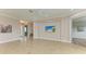 Spacious living area with tile floors and large TV at 5023 Tobermory Way, Bradenton, FL 34211