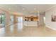 Open living room and kitchen with tile flooring and access to backyard at 5023 Tobermory Way, Bradenton, FL 34211