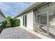 Spacious paved patio with sliding glass doors leading to the interior and a screened enclosure at 5023 Tobermory Way, Bradenton, FL 34211