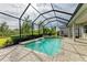 Inviting screened pool with spa and tranquil water features at 5023 Tobermory Way, Bradenton, FL 34211