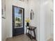 Bright and airy entryway with a modern console table and mirror at 5118 Horizon Edge Cv, Bradenton, FL 34211