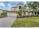 Two-story house with a paved driveway and landscaped lawn at 520 Mimosa Ct, Bradenton, FL 34212