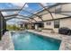 Large screened pool area with hot tub and patio furniture at 520 Mimosa Ct, Bradenton, FL 34212