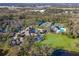 Aerial view showcasing clubhouse, pool, tennis courts, and surrounding landscape at 5318 88Th E St, Bradenton, FL 34211