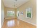 Bright bedroom with hardwood floors and multiple windows at 5318 88Th E St, Bradenton, FL 34211