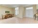 Spacious dining area with hardwood table and chairs, and large windows at 5318 88Th E St, Bradenton, FL 34211