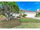 Landscaped front yard with lush greenery and a paved walkway at 5318 88Th E St, Bradenton, FL 34211