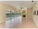 Bright Gathering room with fireplace, tile floors, and sliding doors to pool at 5318 88Th E St, Bradenton, FL 34211