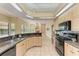 Open kitchen with large island, granite counters, and black appliances at 5318 88Th E St, Bradenton, FL 34211
