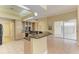 Modern kitchen with island, granite countertops, and stainless steel appliances at 5318 88Th E St, Bradenton, FL 34211