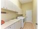 Laundry room with washer, dryer, cabinets and sink at 5318 88Th E St, Bradenton, FL 34211