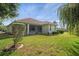 Well-maintained backyard with lush lawn and home view at 5351 Laurel Oak Ct, North Port, FL 34287