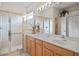 Elegant bathroom with a double vanity and a walk-in shower at 5351 Laurel Oak Ct, North Port, FL 34287