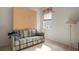 Versatile bonus room with a comfortable sofa and a murphy bed at 5351 Laurel Oak Ct, North Port, FL 34287