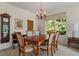 Bright dining room with wood table and chandelier at 5351 Laurel Oak Ct, North Port, FL 34287