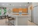 Spacious kitchen with light wood cabinets and island at 5351 Laurel Oak Ct, North Port, FL 34287