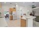 Open kitchen with island and view into dining area at 5351 Laurel Oak Ct, North Port, FL 34287
