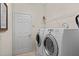 Bright laundry room with washer, dryer, and shelving at 5351 Laurel Oak Ct, North Port, FL 34287