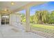 Spacious screened porch with white bench and tranquil backyard view at 5351 Laurel Oak Ct, North Port, FL 34287