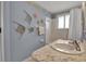 Bathroom features a vanity, tub and decorative wall art at 5708 Miami Rd, Venice, FL 34293