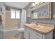 Bright bathroom with tiled tub and vanity at 5708 Miami Rd, Venice, FL 34293