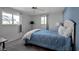 Bedroom with full bed, ceiling fan, and blue accent wall at 5708 Miami Rd, Venice, FL 34293