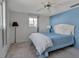 Bedroom with full bed, ceiling fan, and blue accent wall at 5708 Miami Rd, Venice, FL 34293