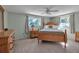 Spacious bedroom with wood post bed and ample natural light at 5708 Miami Rd, Venice, FL 34293