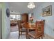 Bright dining area with a wooden table and chairs, near the living room at 5708 Miami Rd, Venice, FL 34293
