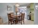 Cozy dining room featuring a wood table, four chairs and access to the patio at 5708 Miami Rd, Venice, FL 34293
