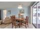 Charming dining area with wood table and chairs, and a view to the lanai at 5708 Miami Rd, Venice, FL 34293