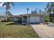 Single-story home with a spacious yard and attached garage at 5708 Miami Rd, Venice, FL 34293
