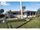 Home featuring a large screened porch and nicely landscaped yard at 5708 Miami Rd, Venice, FL 34293