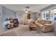 Living room features pale blue walls, comfy seating, and a ceiling fan at 5708 Miami Rd, Venice, FL 34293