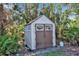 Beige and brown storage shed with double doors at 5708 Miami Rd, Venice, FL 34293