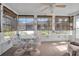 Sunroom with table, chairs, and relaxing recliner at 5708 Miami Rd, Venice, FL 34293