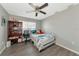 Bedroom with a full-size bed, ceiling fan, and built-in shelving at 5806 15Th W St, Bradenton, FL 34207