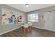 Bright dining area with a glass table, white chairs, and built-in shelving at 5806 15Th W St, Bradenton, FL 34207