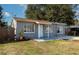 Gray house with a fenced yard, driveway, and mature trees at 5806 15Th W St, Bradenton, FL 34207