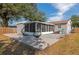 Backyard view of house, deck, and screened porch at 5806 15Th W St, Bradenton, FL 34207