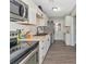 Modern kitchen with white cabinets, butcher block countertops, and stainless steel appliances at 5806 15Th W St, Bradenton, FL 34207