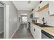 Modern kitchen with white cabinets, subway tile backsplash, and stainless steel appliances at 5806 15Th W St, Bradenton, FL 34207
