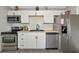Updated kitchen featuring white cabinets, stainless steel appliances, and wood-look countertops at 5806 15Th W St, Bradenton, FL 34207
