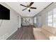 Open living and dining area with a light beige couch, wood-look floors, and a large TV at 5806 15Th W St, Bradenton, FL 34207